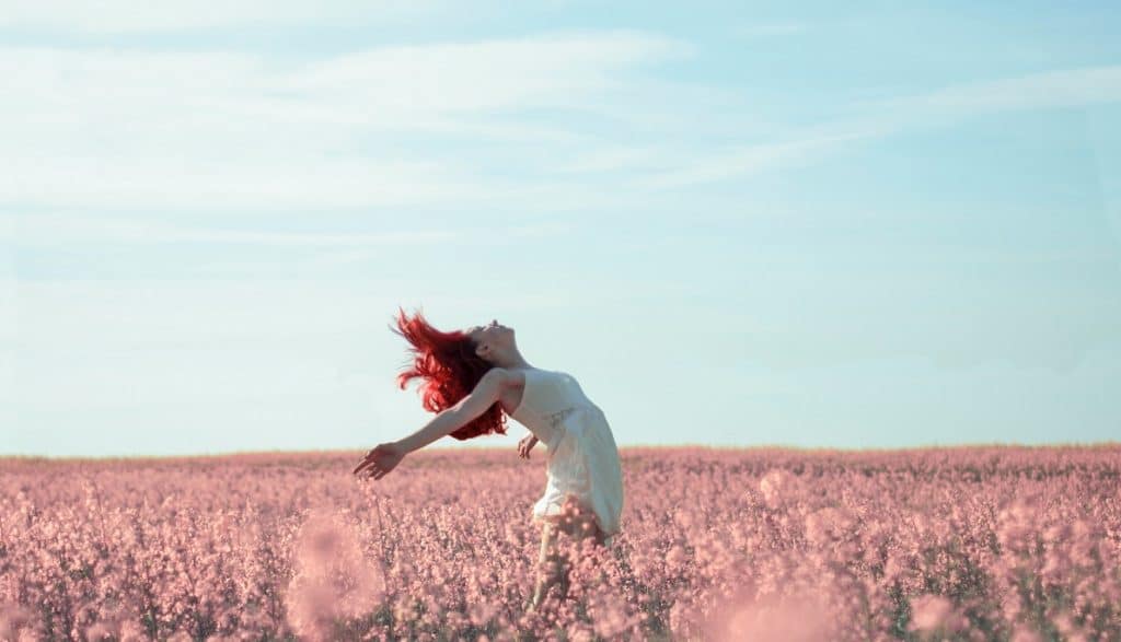 selbstliebe-lernen-vergessene-kraft-die-gluecklich-macht-frau-happy-feld